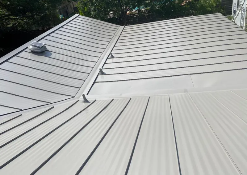 Solar attic fan installed on a metal roof for Roof Ventilation in Iroquois Point